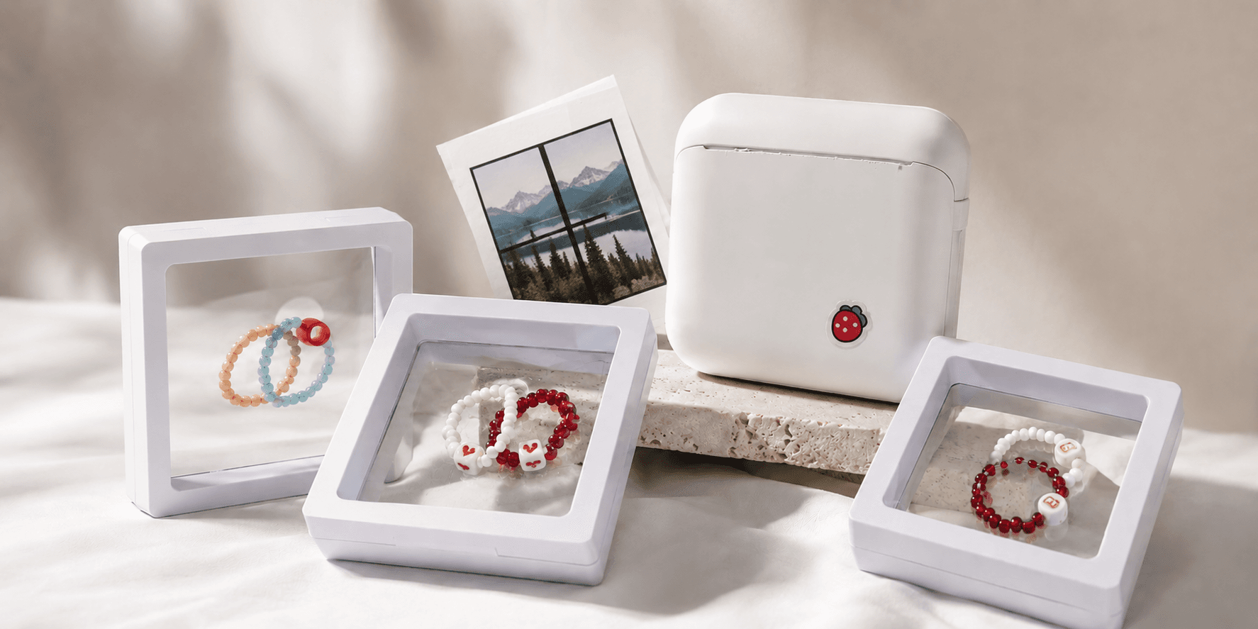 A flat-lay of efca. beaded bracelets, name charms and gift boxes