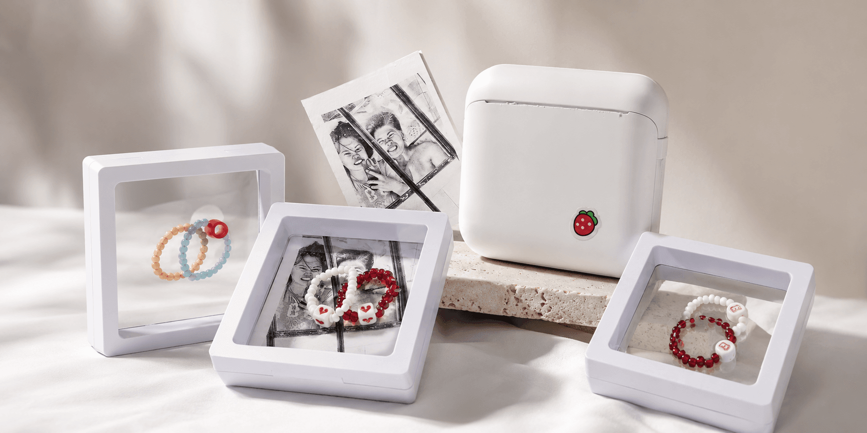 A flat-lay of efca. beaded bracelets, name charms and gift boxes
